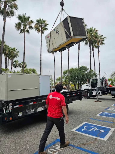 Comfort Time crew guiding a crane lift of a rooftop AC unit